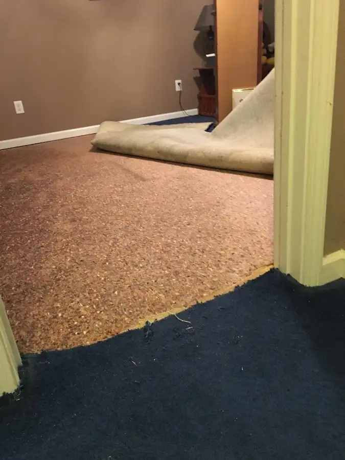 Carpet pad removal revealing water damage during Drying & Dehumidification in Pacific Grove